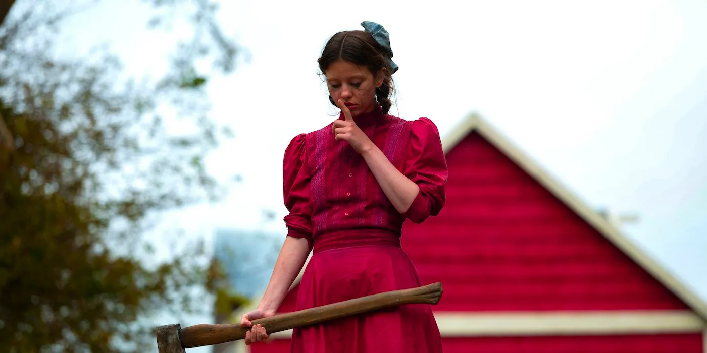 Mia Goth standing holding an ax in Pearl. Image