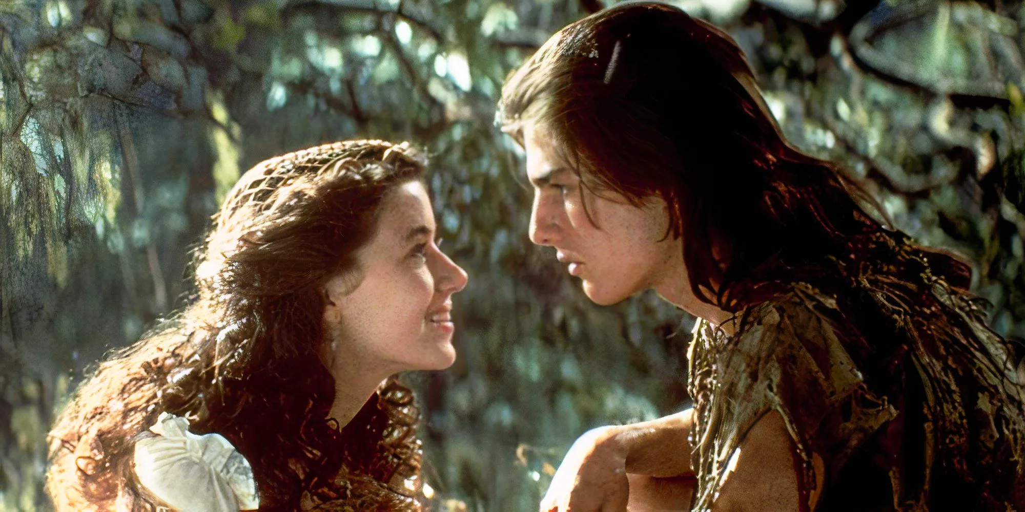 Mia Sara as Lili and Tom Cruise as Jack looking at each other intently in Legend Image