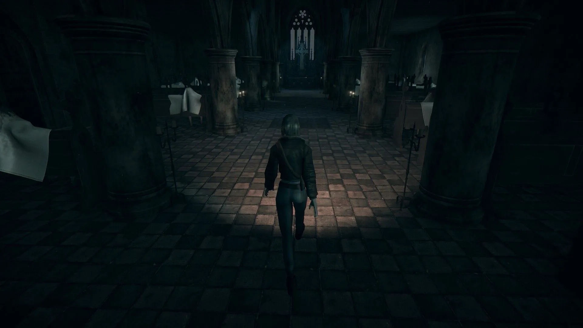 Mica from Hollowbody walking through a dark church with a flashlight. Image