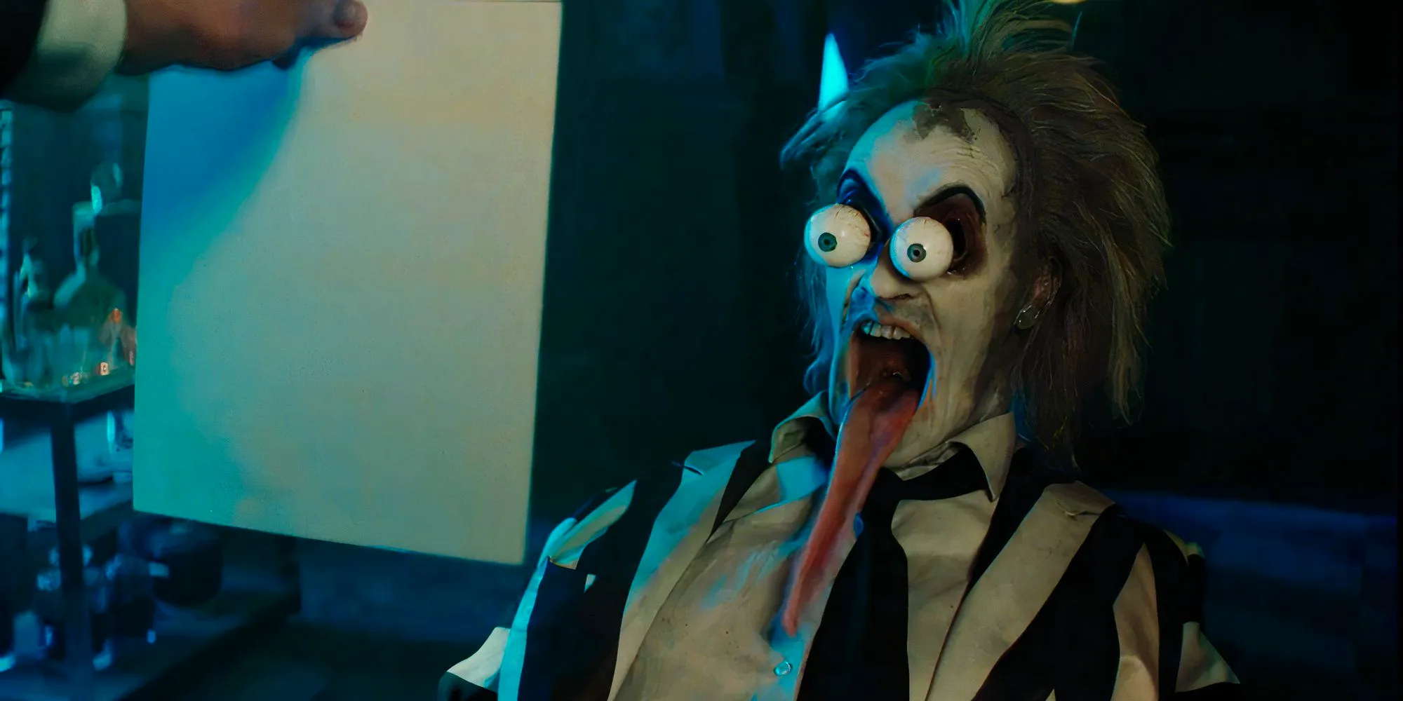 Michael Keaton as Betelgeuse bugging out his eyes in shock in Beetlejuice Beetlejuice Image