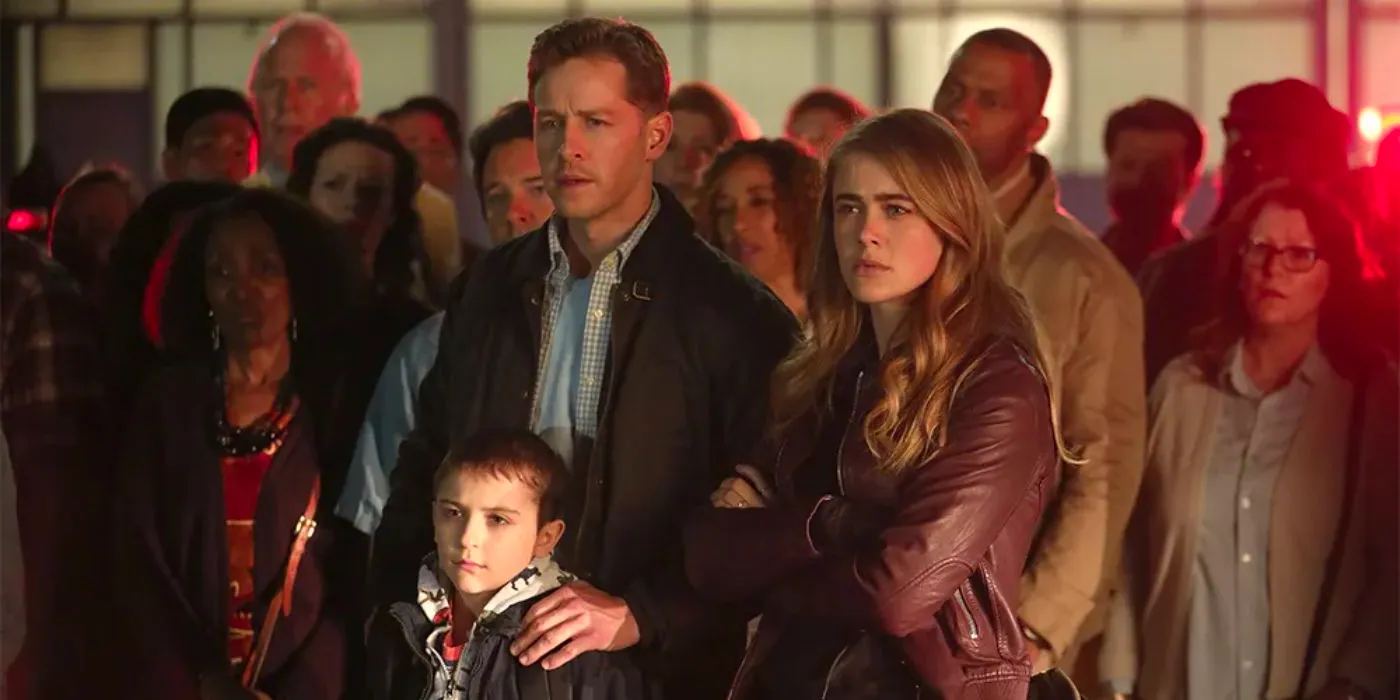 Michaela, Ben, and Cal looking concerned and standing in front of the other Flight 828 passengers Image