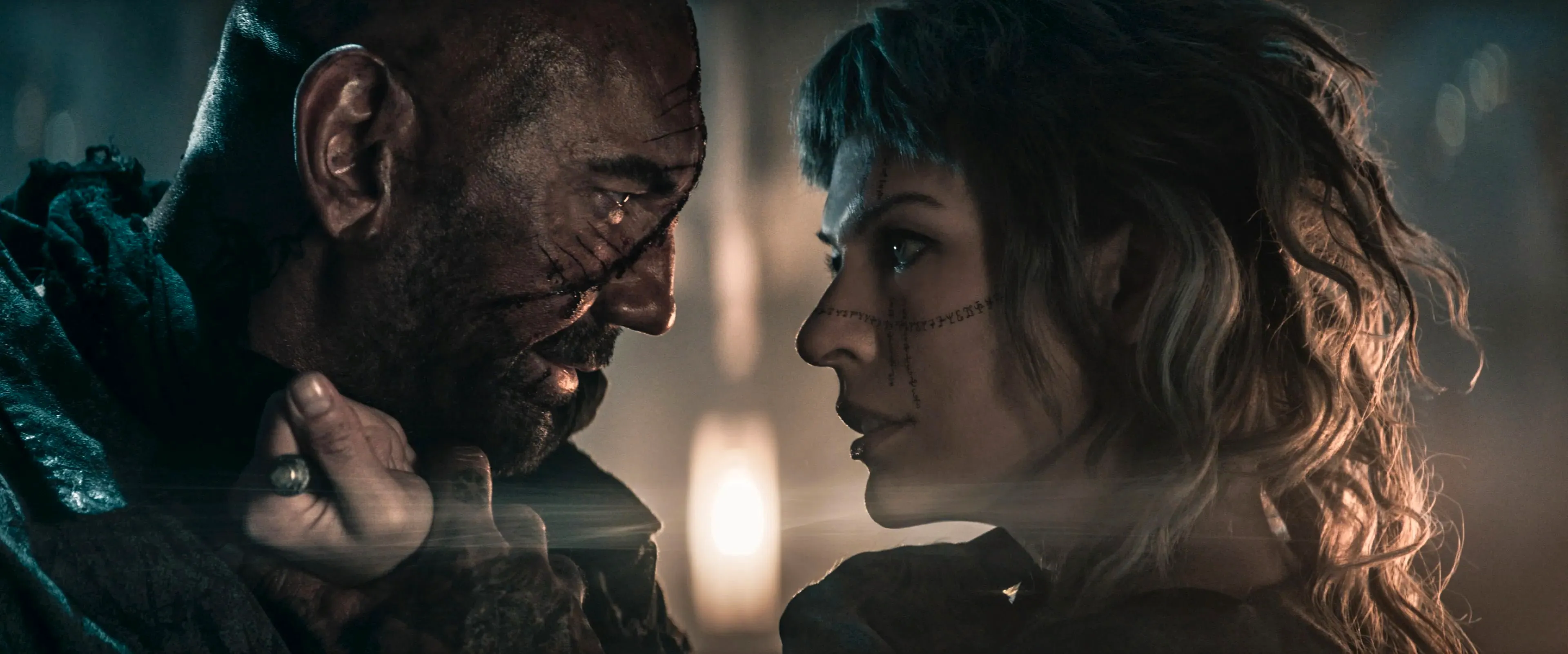 Milla Jovovich as Gray Alys and Dave Bautista as Boyce in In the Lost Lands Image