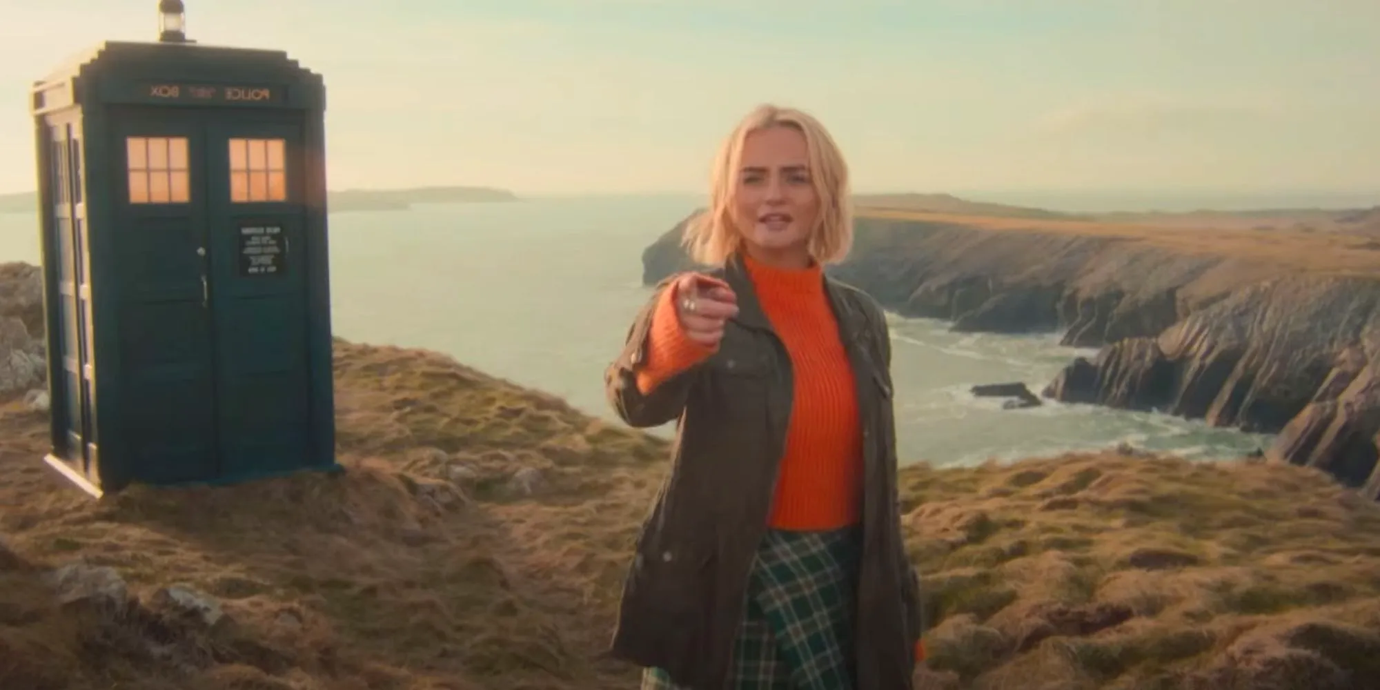 Millie Gibson as Ruby Sunday pointing on a cliff in Doctor Who. Image