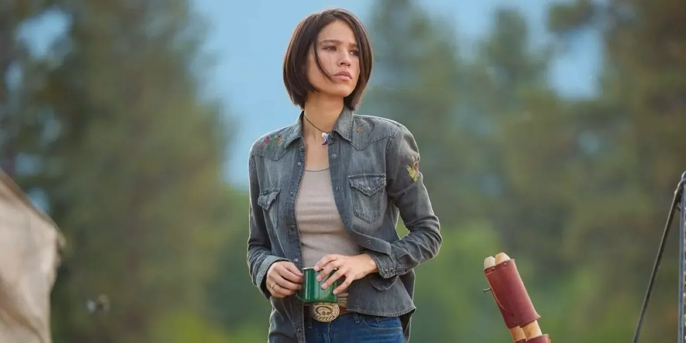 Monica Dutton (Kelsey Asbille) standing with a cup in Yellowstone Image