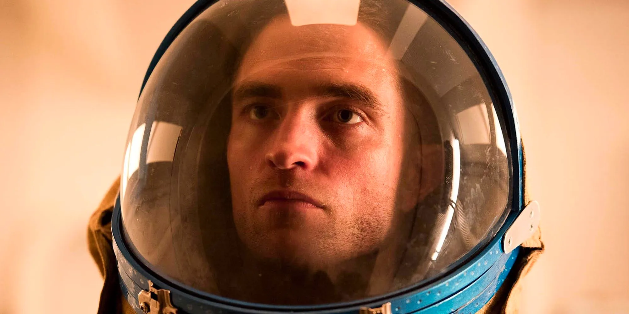 Monte is in his space helmet with a stern look on his face in High Life. Image