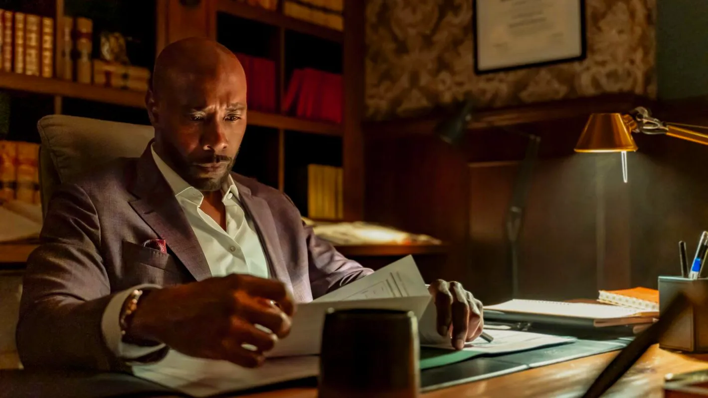 Morris Chestnut as Watson looking over documents in Watson Image