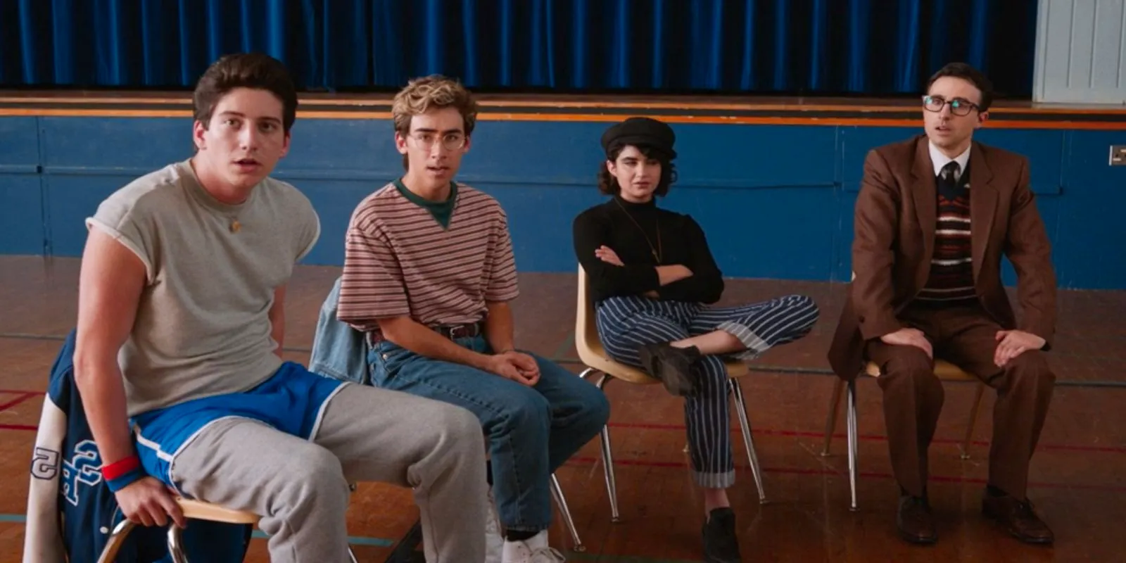 Mr. Martin, Rhonds, Charley, and Wally sitting in chairs in the gym in the School Spirits support group Image