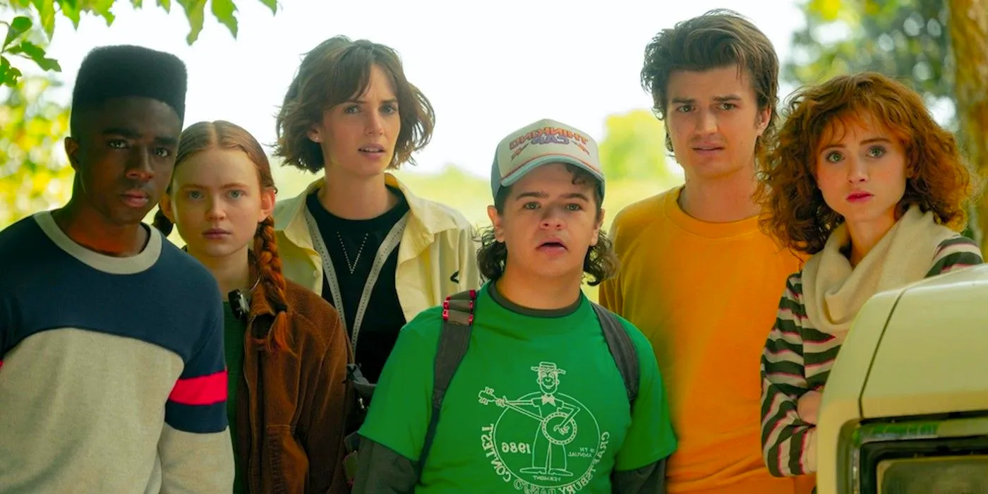 Nancy, Steve, Dustin, Robin, Max, and Lucas standing together outside in Stranger Things season 4 Image