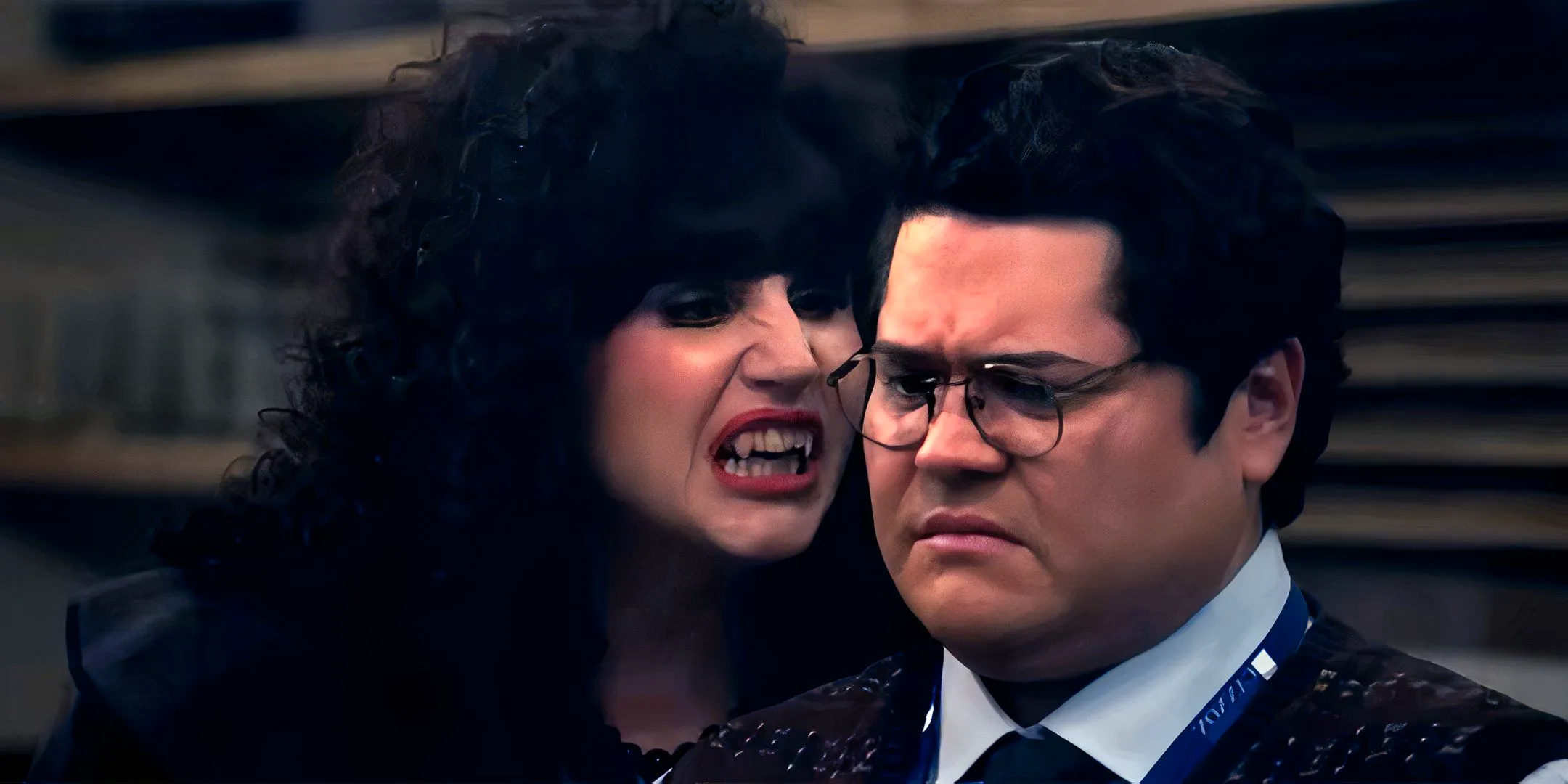 Natasia Demetriou's Nadja hissing near Guillermo's neck in What We Do in the Shadows season 6 Image