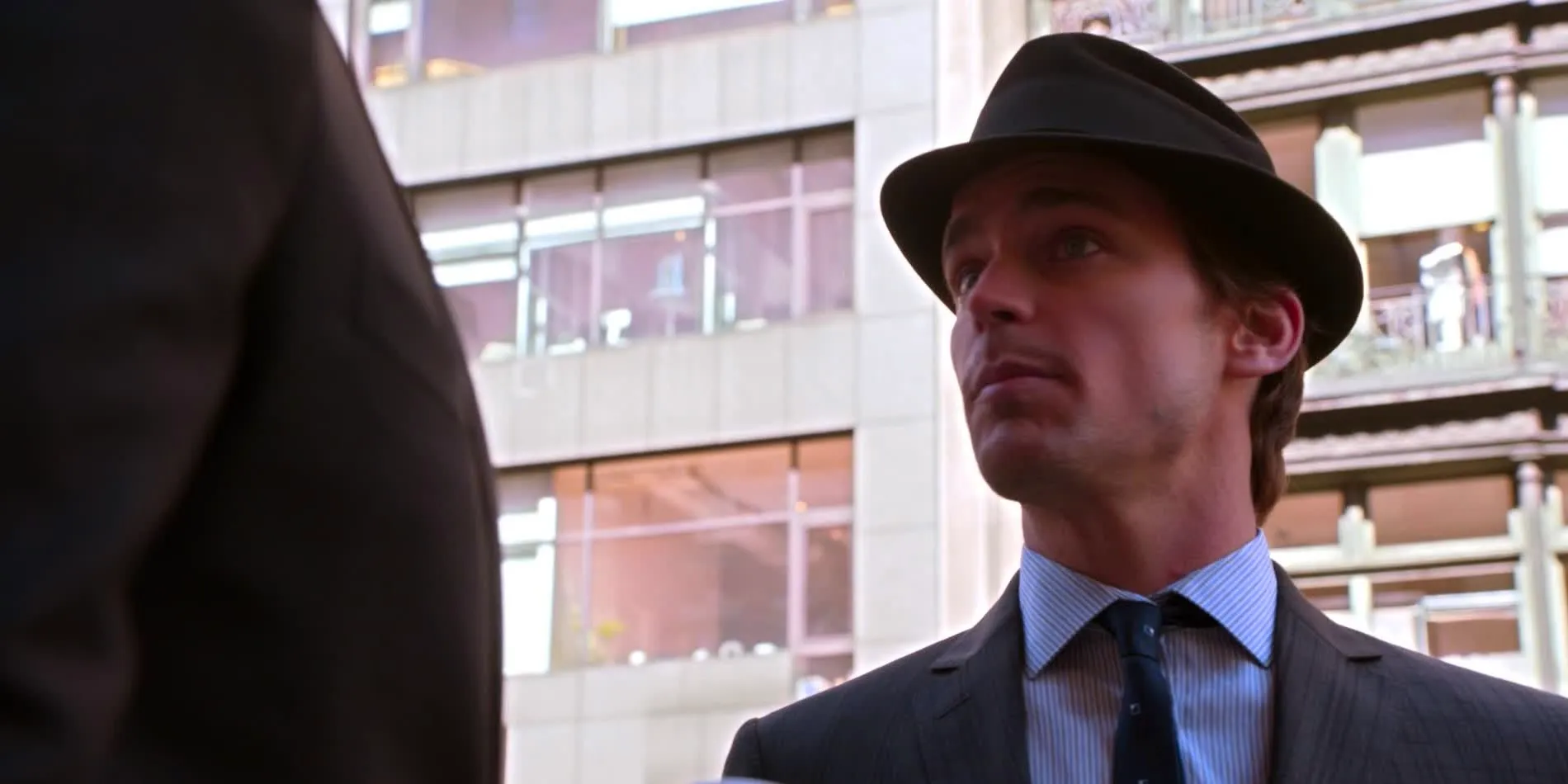 Neal wearing a hat on the street in White Collar. Image