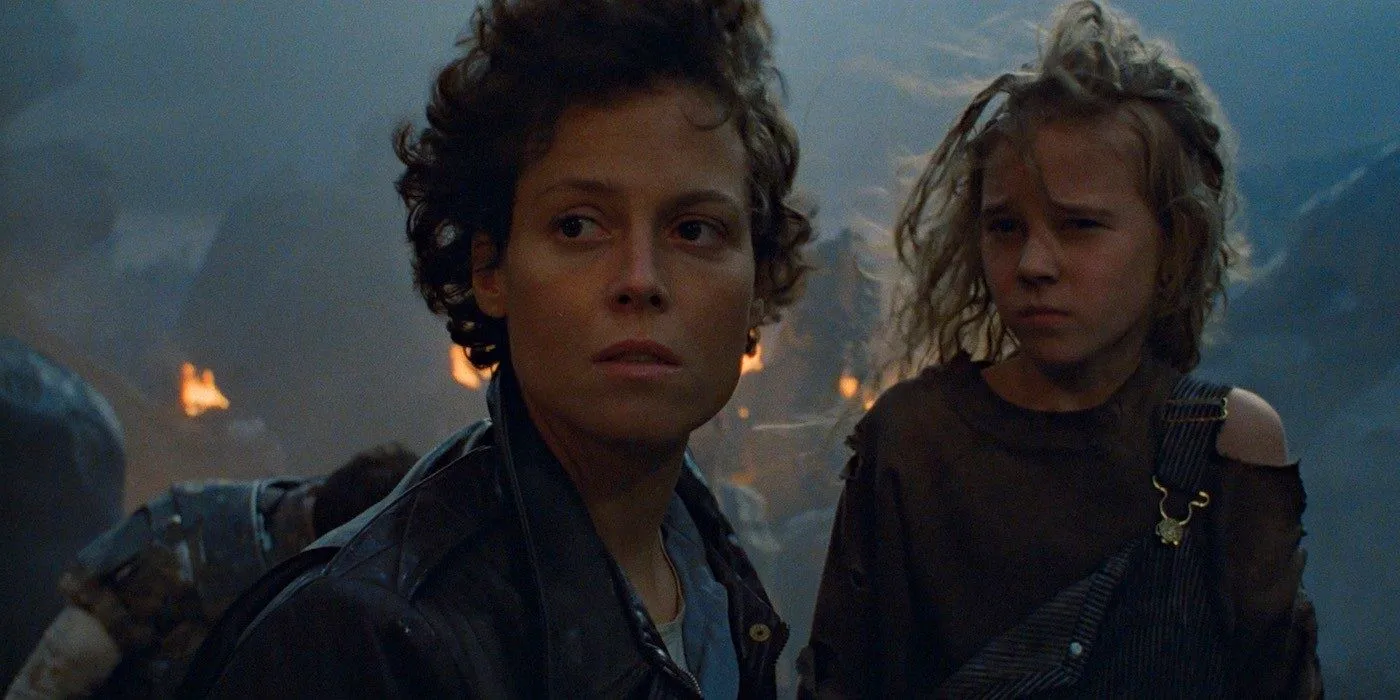 Newt and Ripley look over a burnt battlefield in Aliens Image