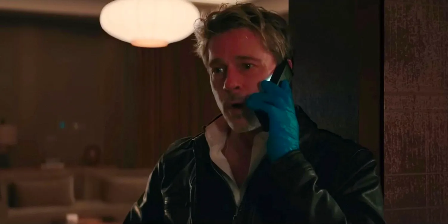 Nick (Brad Pitt) wearing latex gloves while making a call in WOLFS Image