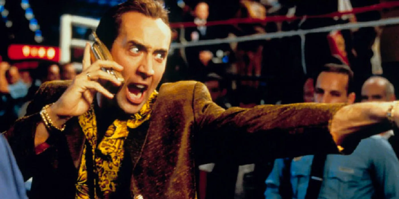 Nicolas Cage screaming into a cell phone in Snake Eyes Image