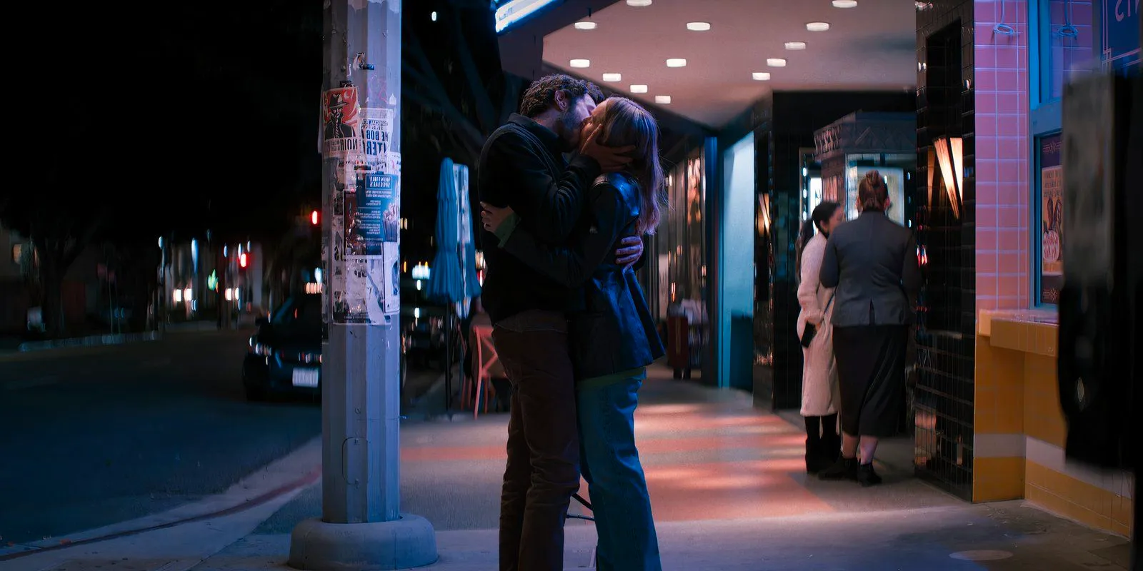 Noah and Joanne kiss while standing on the sidewalk in Nobody Wants This. Image