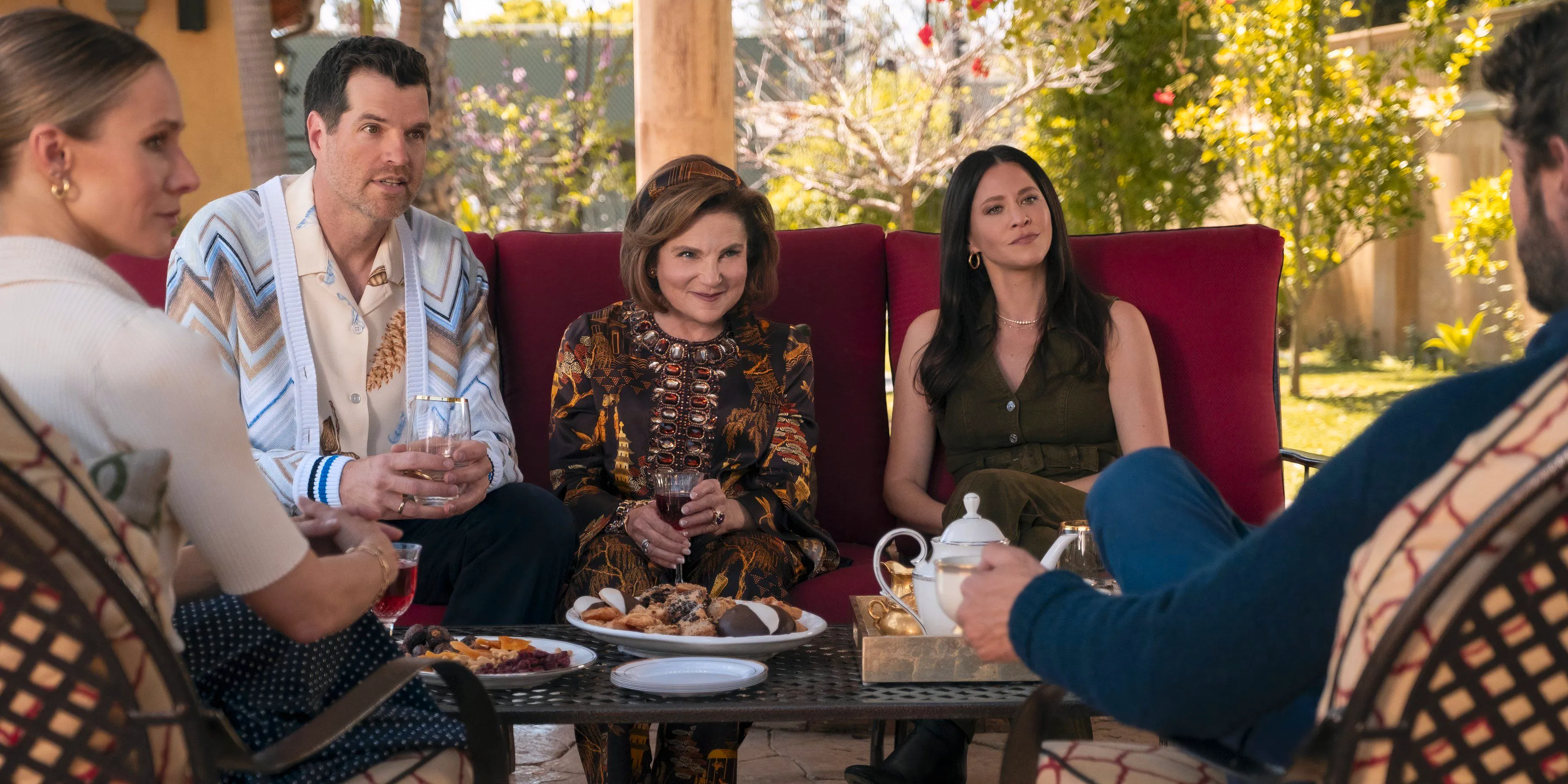 Noah, Esther, Bina, Sasha, and Joanne sit around an outdoor table in Nobody Wants This Image