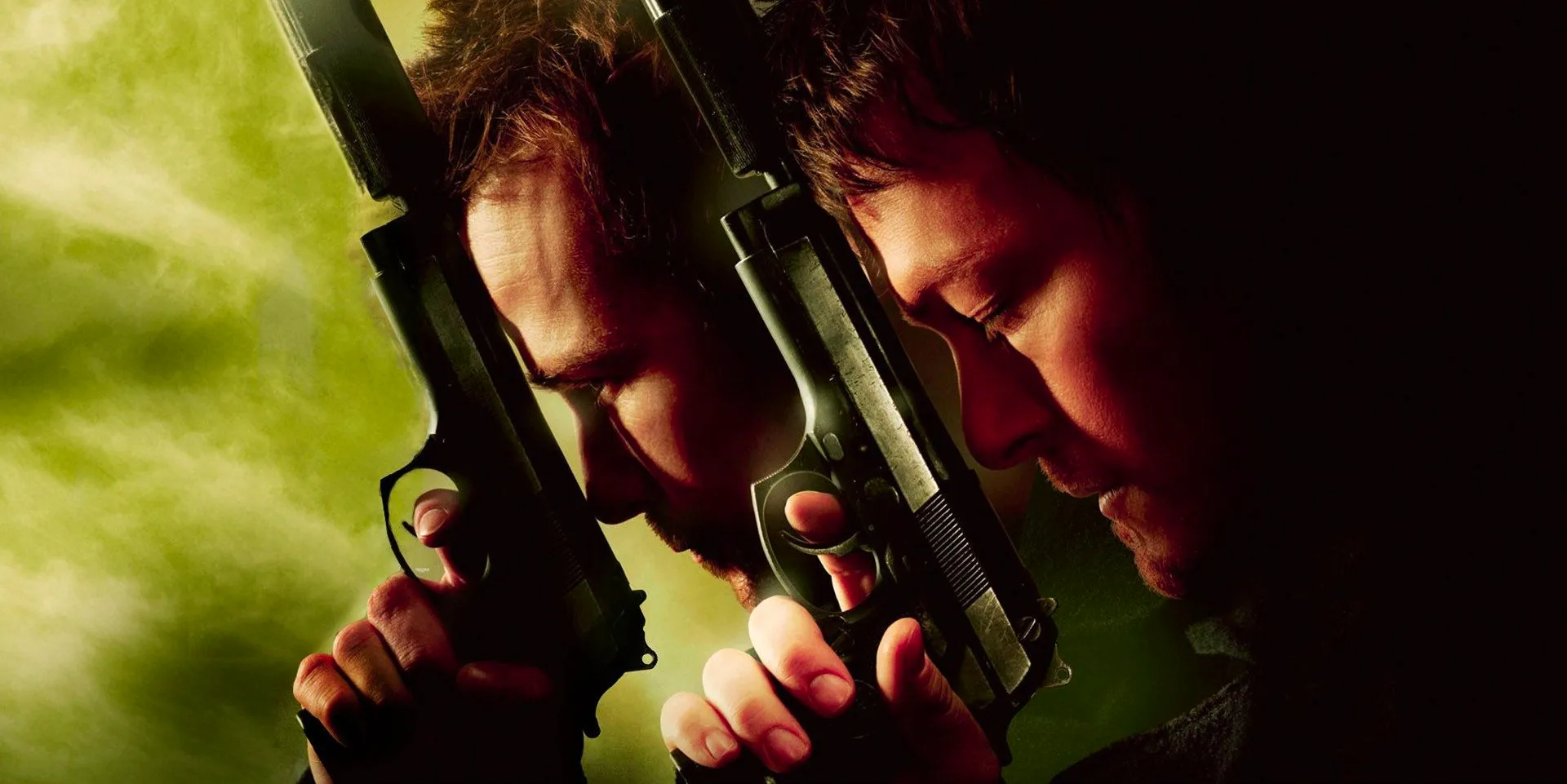 Norman Reedus and Sean Patrick Flanery holding guns to their foreheads in a promotional image for The Boondock Saints Image