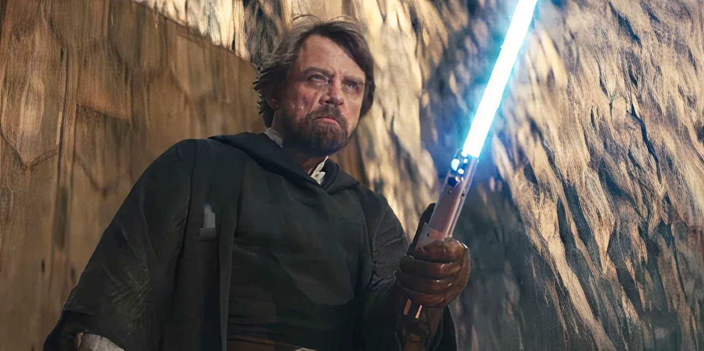 Old Man Luke Skywalker wielding his blue lightsaber. Image