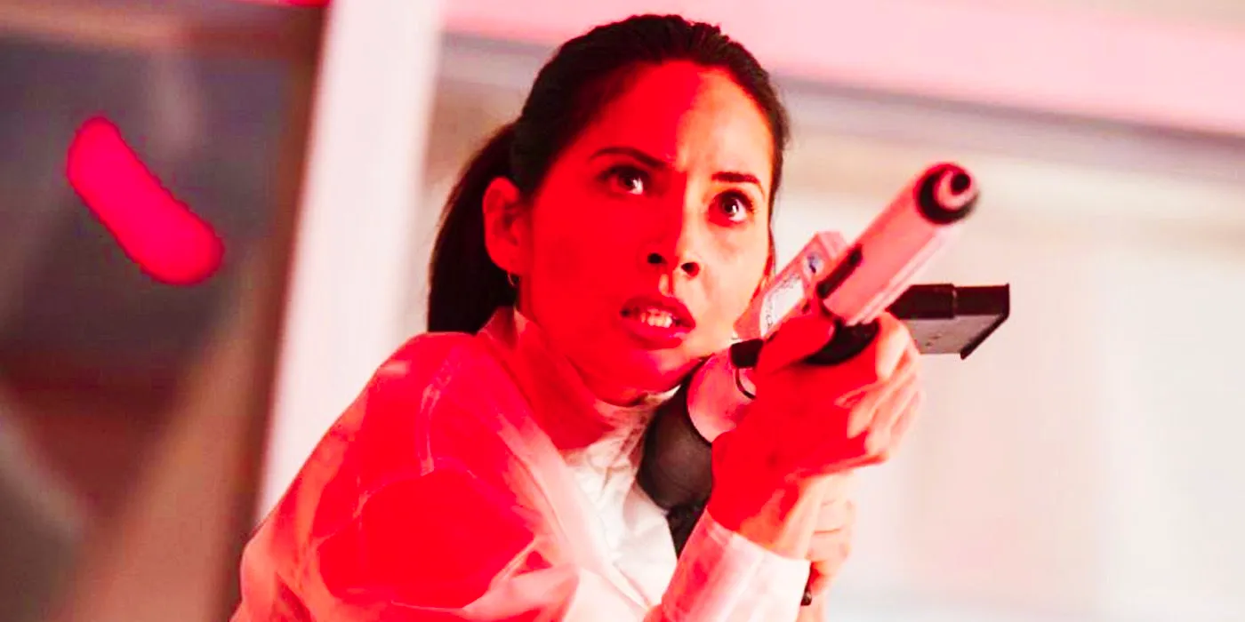 Olivia Munn as Casey Brackett with a gun in The Predator Image