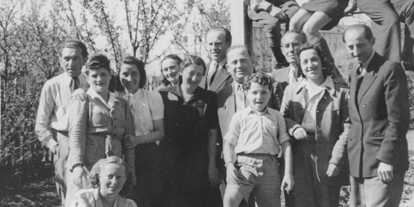 Oskar Schindler posing with Jews in a reunion  Image