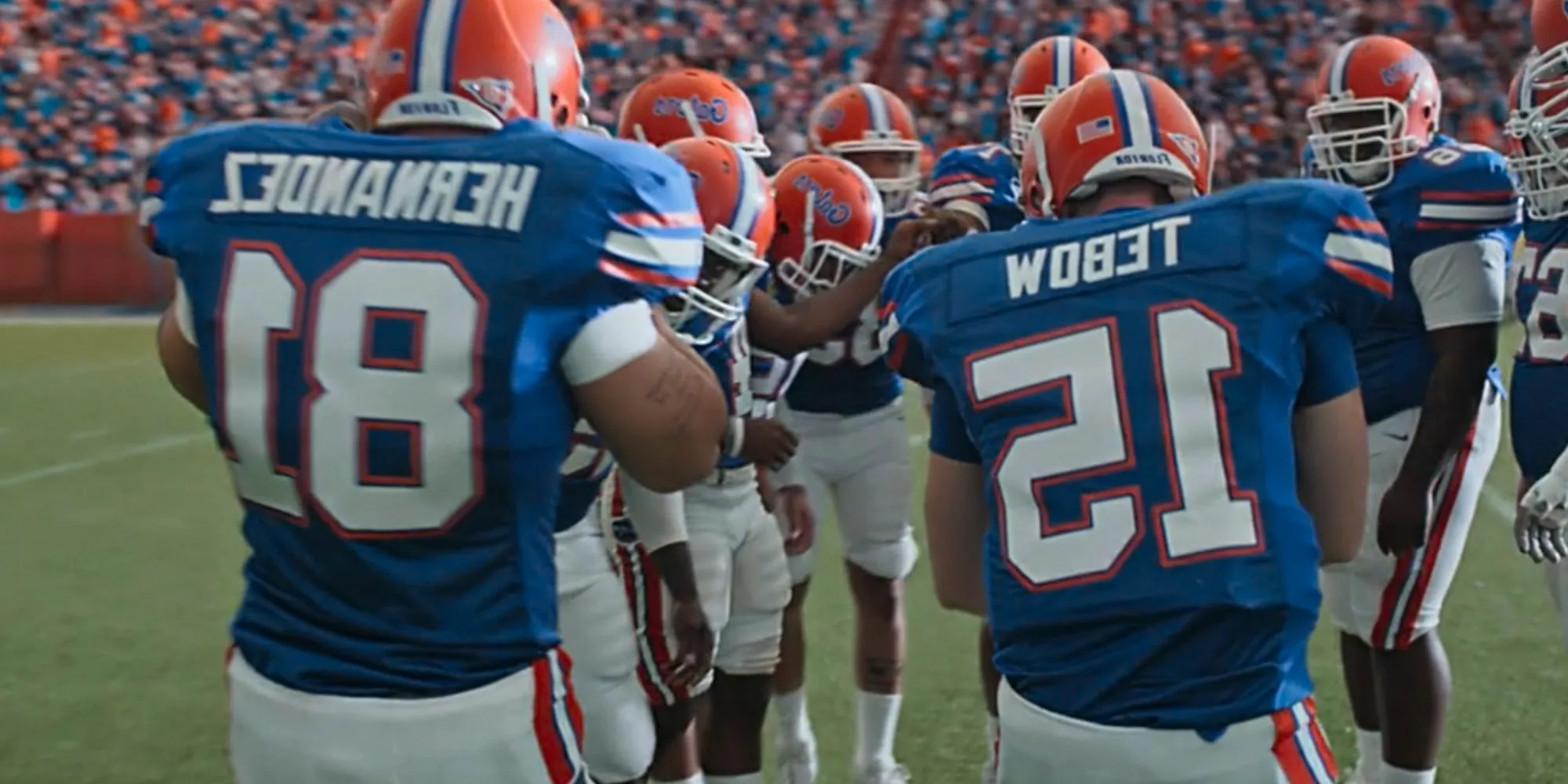 Patrick Schwarzenegger in the huddle as Tim Tebow with Josh Rivera as Aaron Hernandez in American Sports Story Image