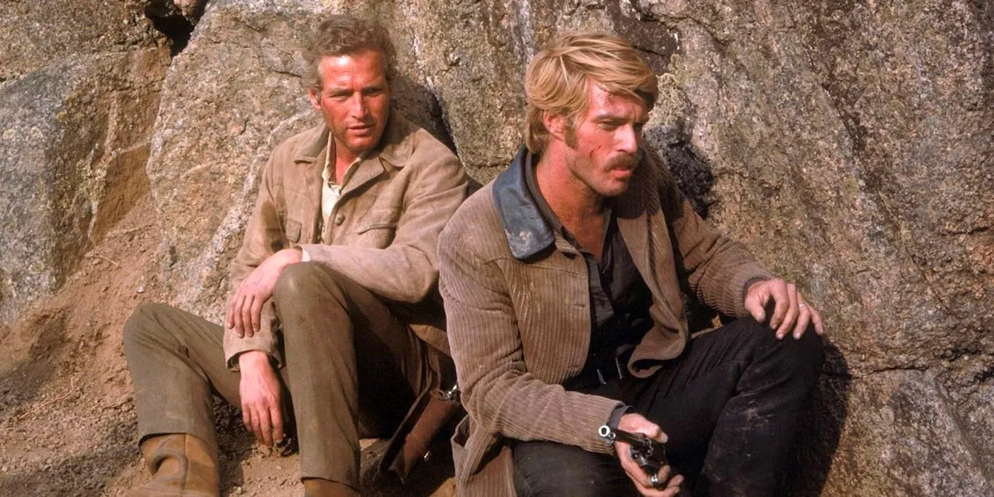 Paul Newman's Butch Cassidy and Robert Redford's Sundance Kid take refuge behind huge rocks in the mountains in Butch Cassidy and the Sundance Kid Image