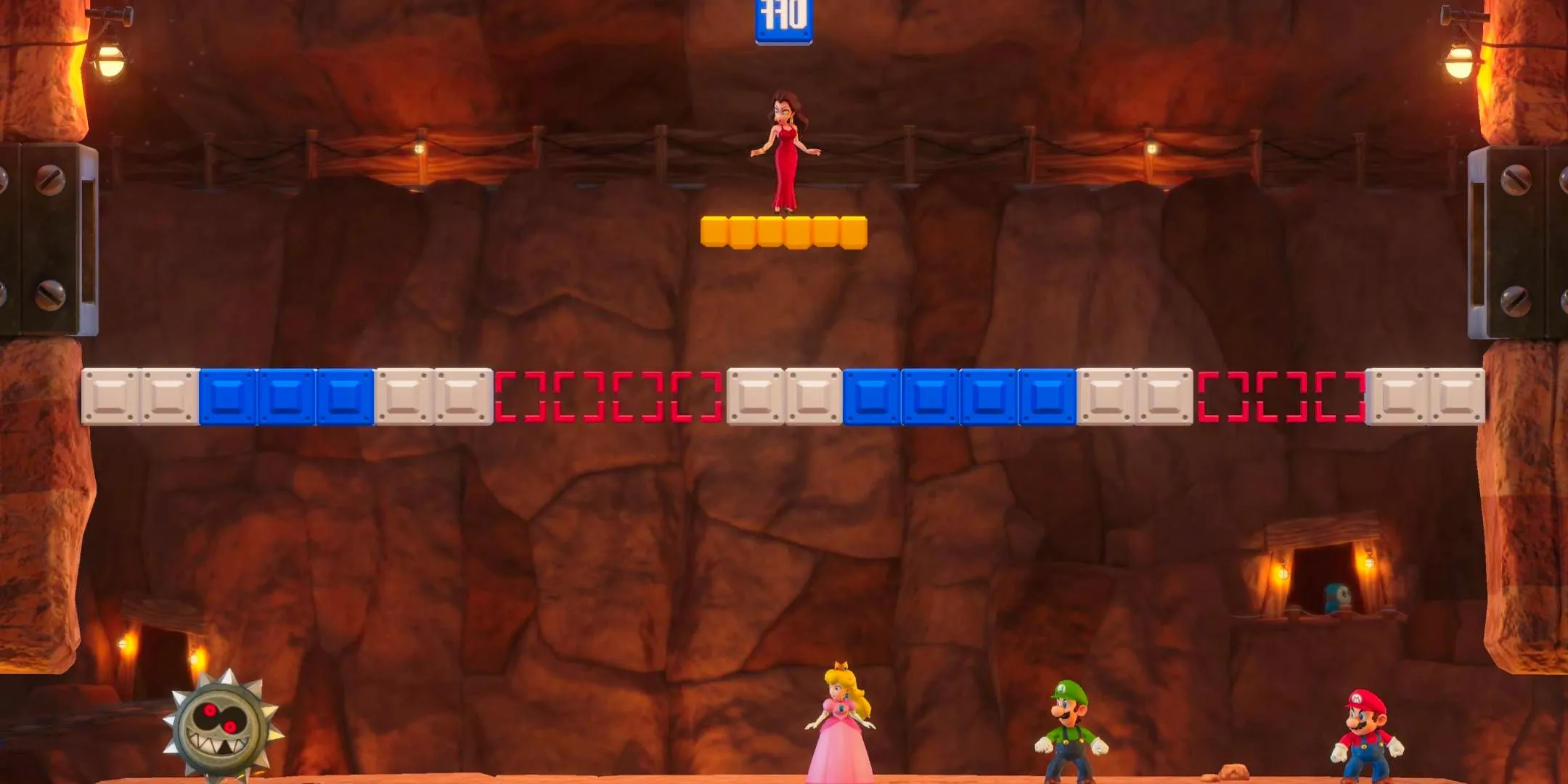 Pauline stood on a yellow platform above Mario, Luigi, and Peach who are staring a spiked wheel in the Mario Party Jamboree minigame On-Again Off-Again. Image