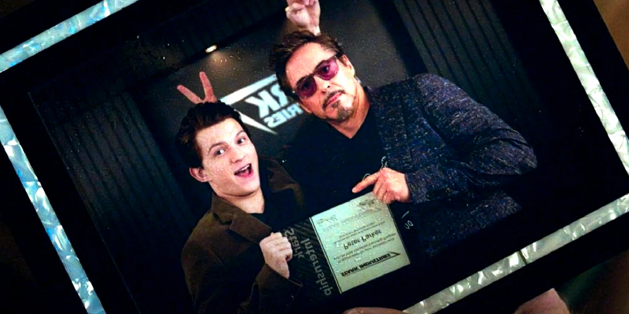 Peter Parker and Tony Stark pose for a photo together in Spider-Man Homecoming and Avengers Endgame Image