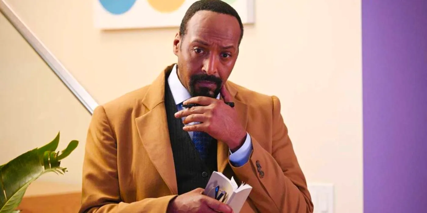 Professor Alec Mercer (Jesse L. Martin) holding a notebook and stroking his chin in The Irrational. Image