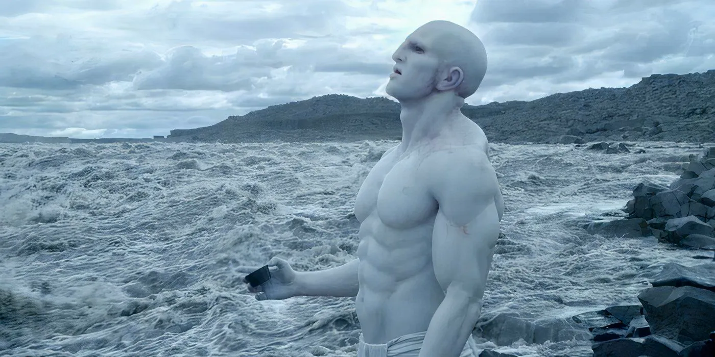 Prometheus' Engineer standing in water, holding a cup filled with Black Goo. Image