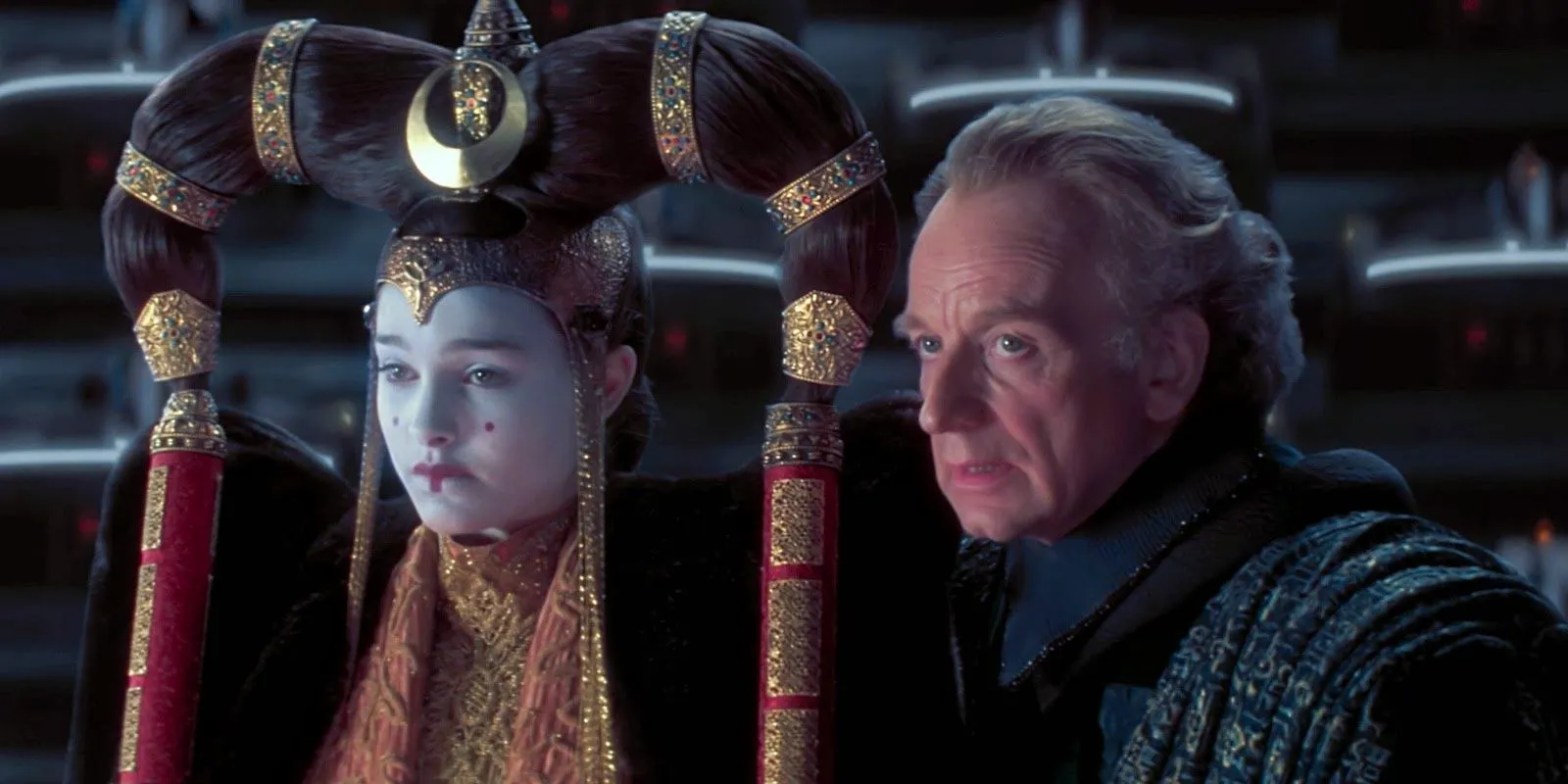 Queen Amidala and Senator Palpatine sit in a Senate hearing in The Phantom Menace Image