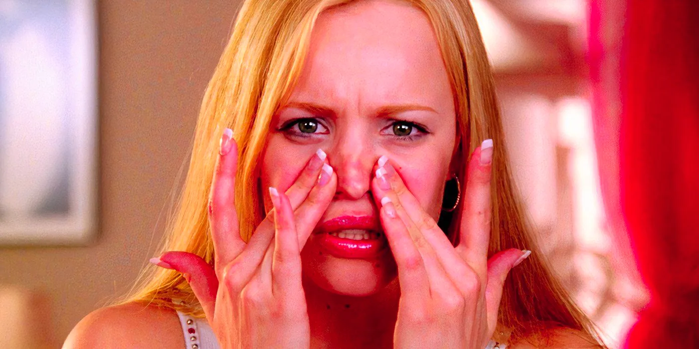 Rachel McAdams as Regina George touching her face while looking in a mirror in Mean Girls 2004 Image