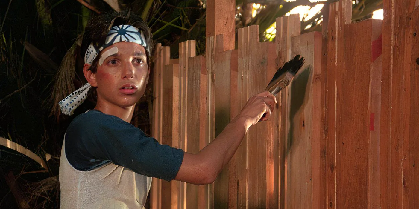 Ralph Macchio as Daniel LaRusso painting a fence in The Karate Kid (1984) Image