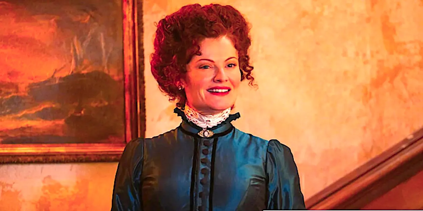 Rebecca Wisocky's Hetty smiles in the hallway in Ghosts season 2 Image