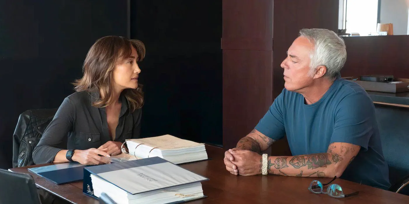 Renee Ballard (Maggie Q) and Harry Bosch (Titus Welliver) talk while sitting at a table on Bosch: Legacy season 3 episode 10 Image