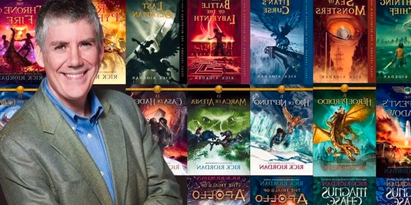 Rick Riordan with his Percy Jackson books and their spinoffs behind him Image