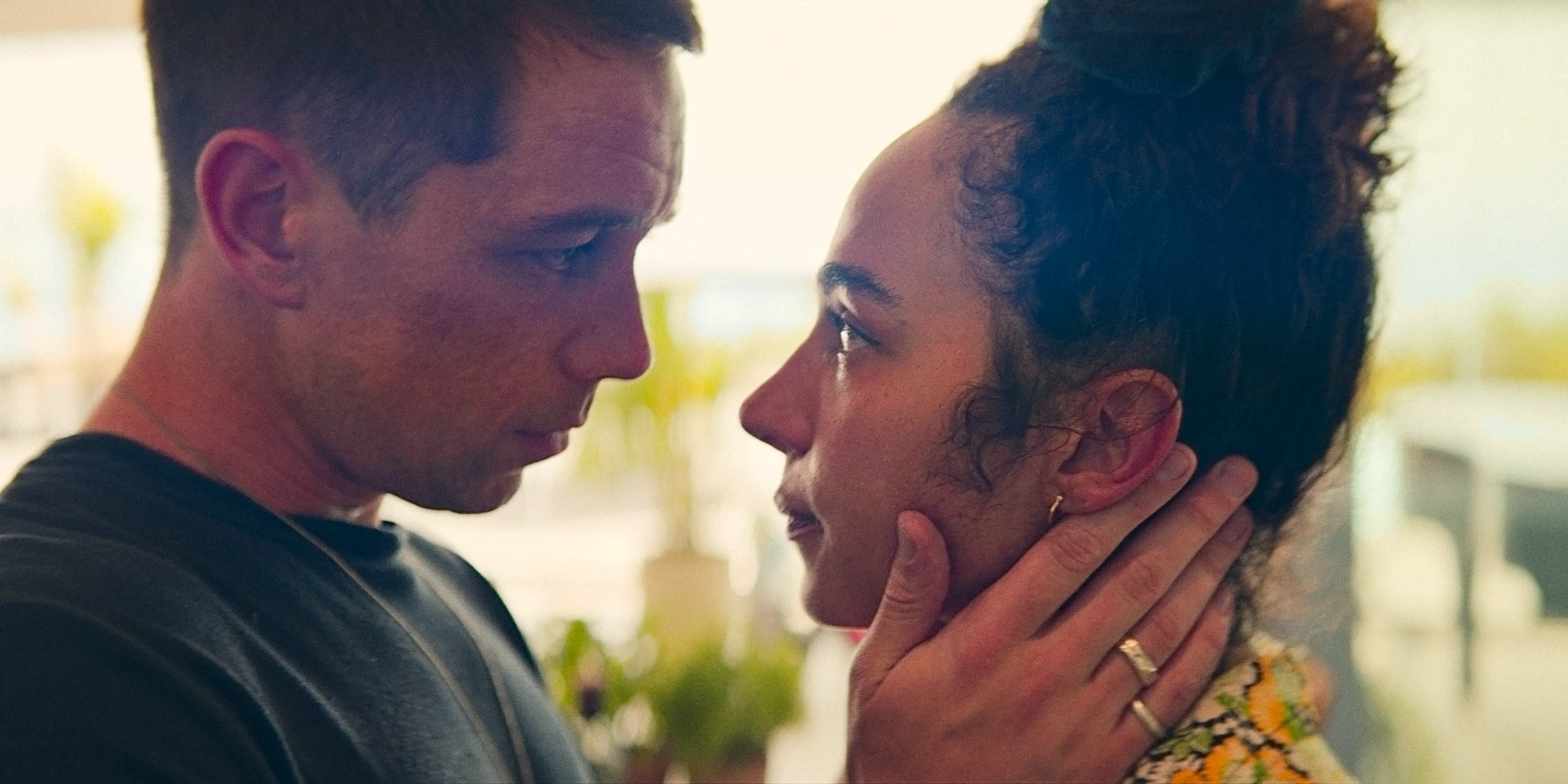 Riddy (Aurora Perrineau) and Orpheus (Killian Scott) looking into each other's eyes, about to kiss in KAOS Season 1 Image