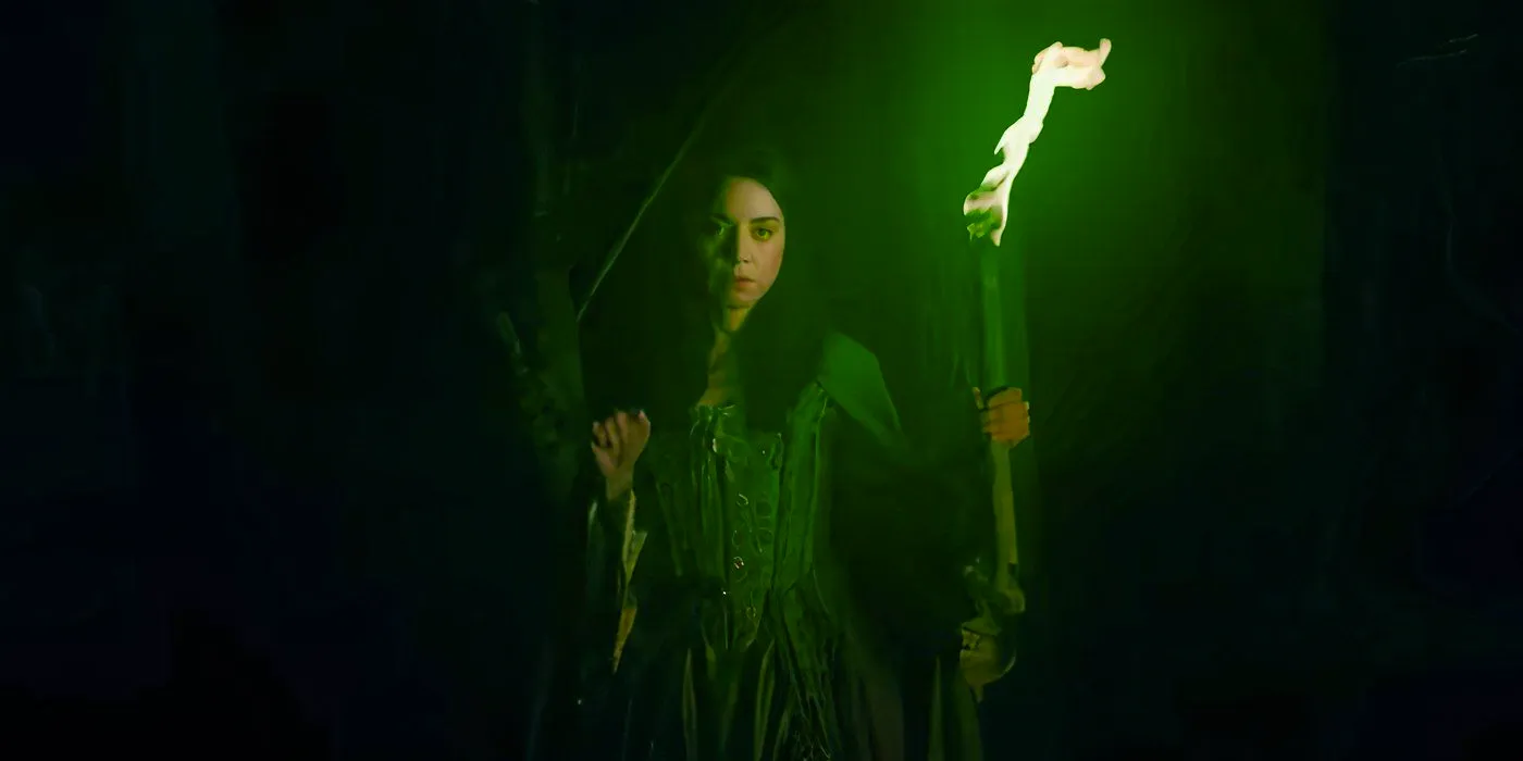 Rio Vidal holds a green torch in a forest in Agatha All Along trailer Image