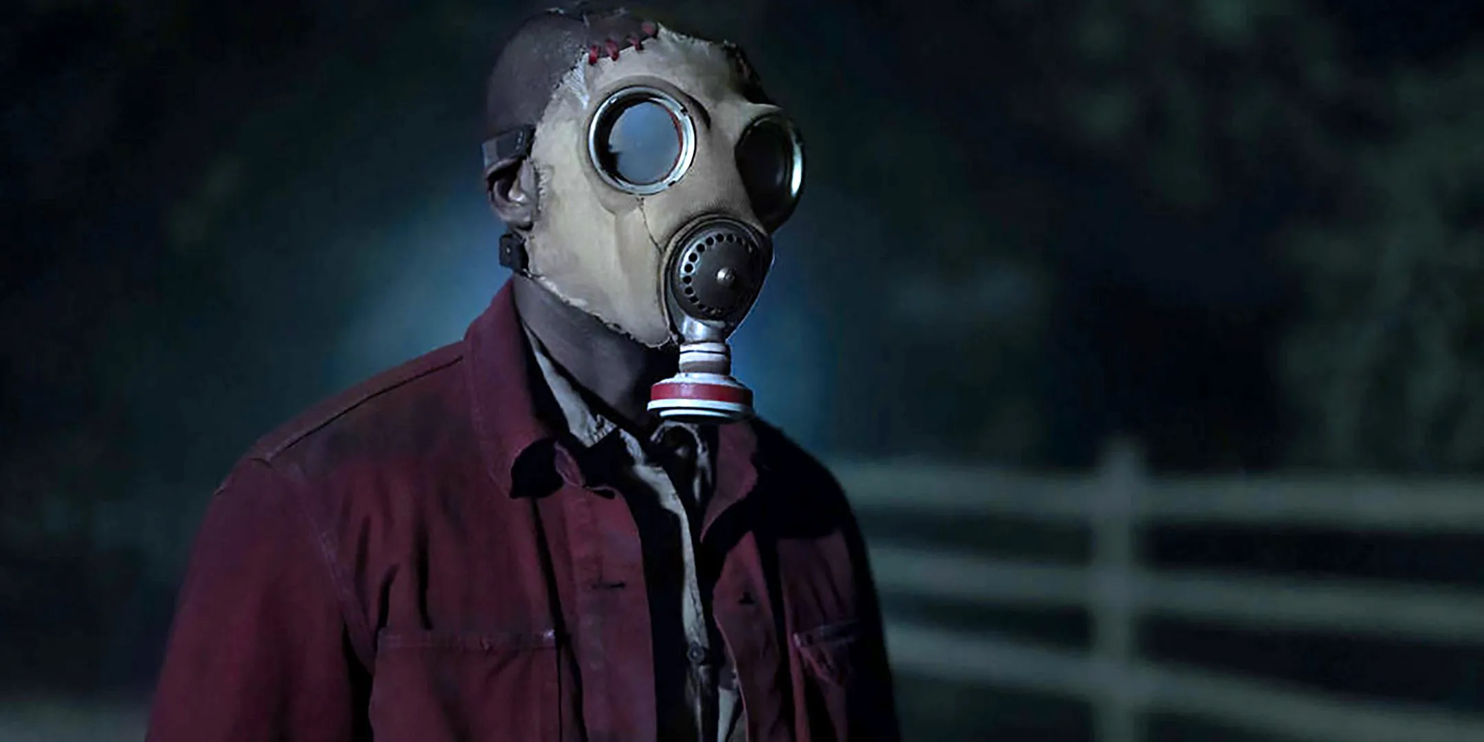 Rob Morgan as McNab wearing a gas mask and standing in the field at night in Teacup Image