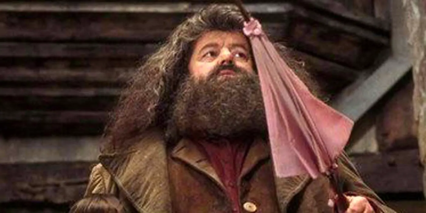 Robbie Coltrane as Hagrid holding his pink umbrella wand in Harry Potter and the Sorcerer's Stone Image