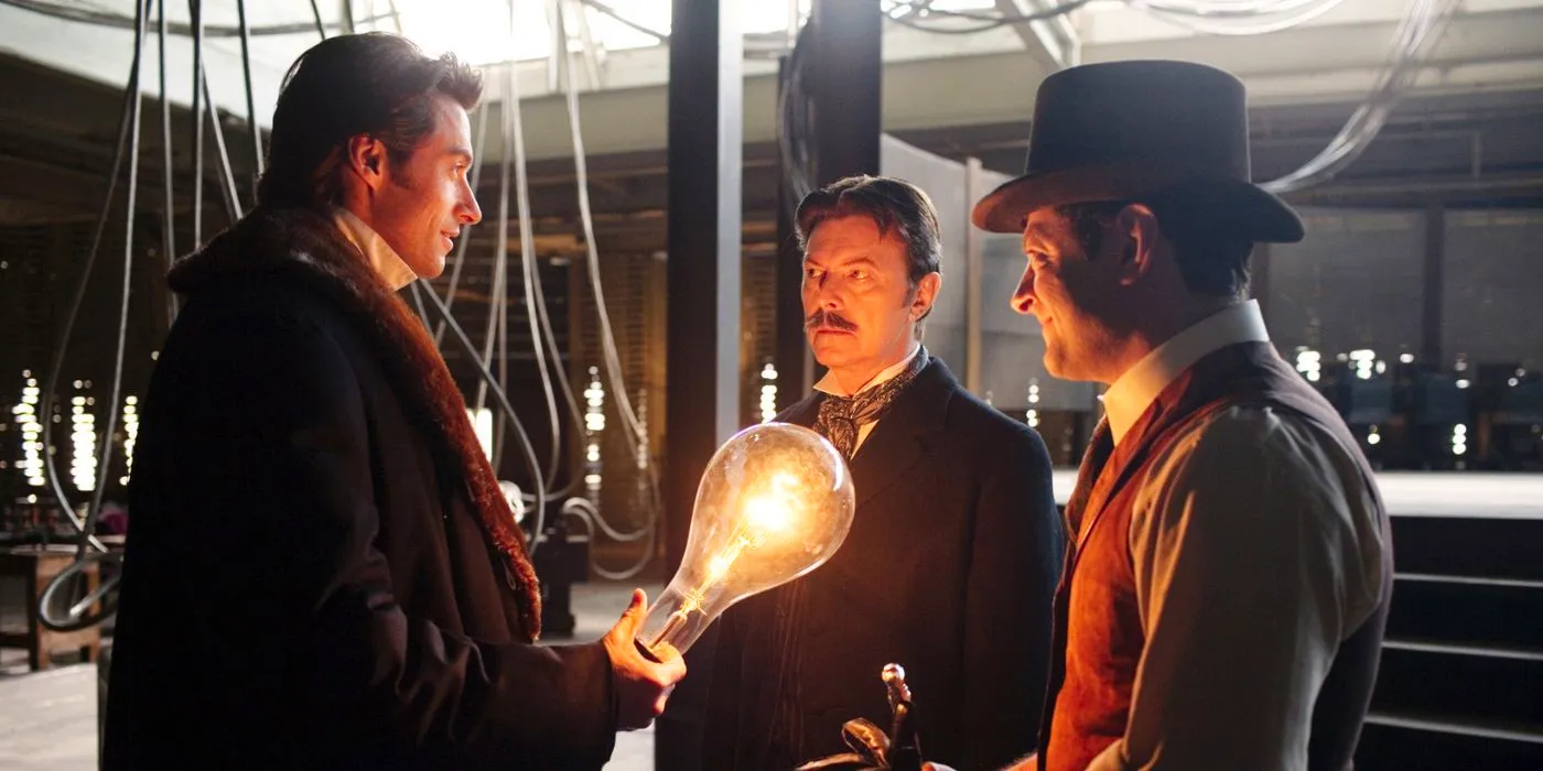 Robert holds a lightbulb and speaks with Tesla in Christopher Nolan's The Prestige Image