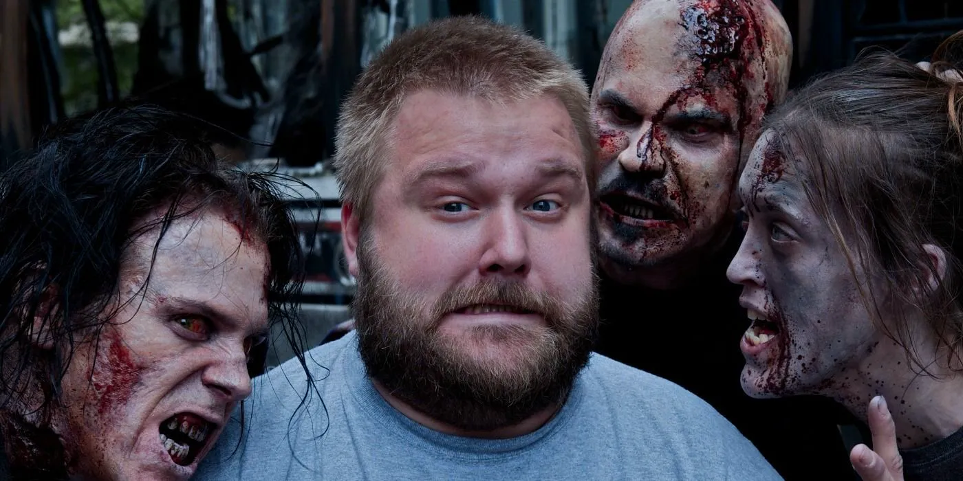 Robert Kirkman surrounded by zombie extras on the set of <a href=https://www.moviesnewstalk.com/comics-special/the-walking-dead-daryl-dixon-season-2-release-date-verified-for-halloween>The Walking Dead</a>. Image