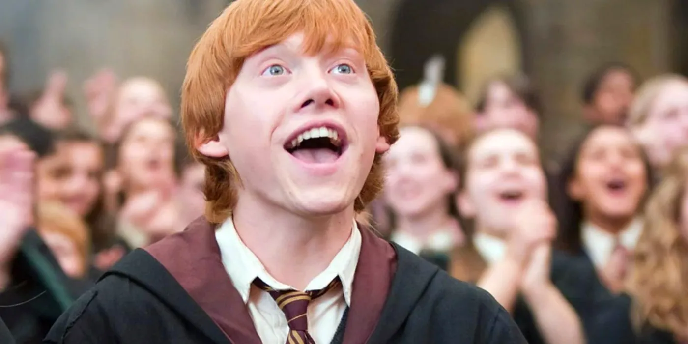 Ron (Rupert Grint) looking up at something with excitement in Harry Potter.  Image