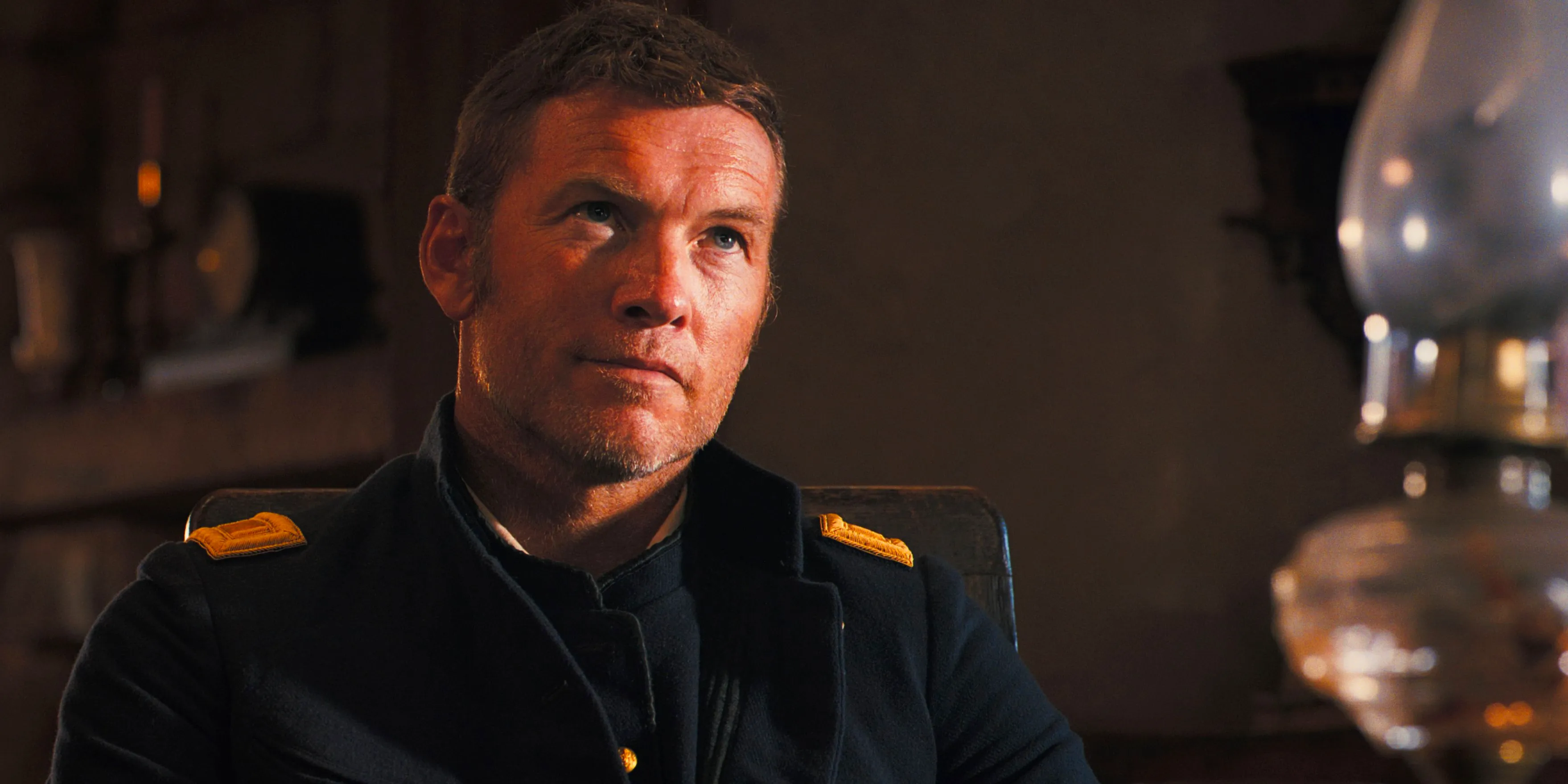 Sam Worthington looks up skeptically in Horizon Chapter 2 Image