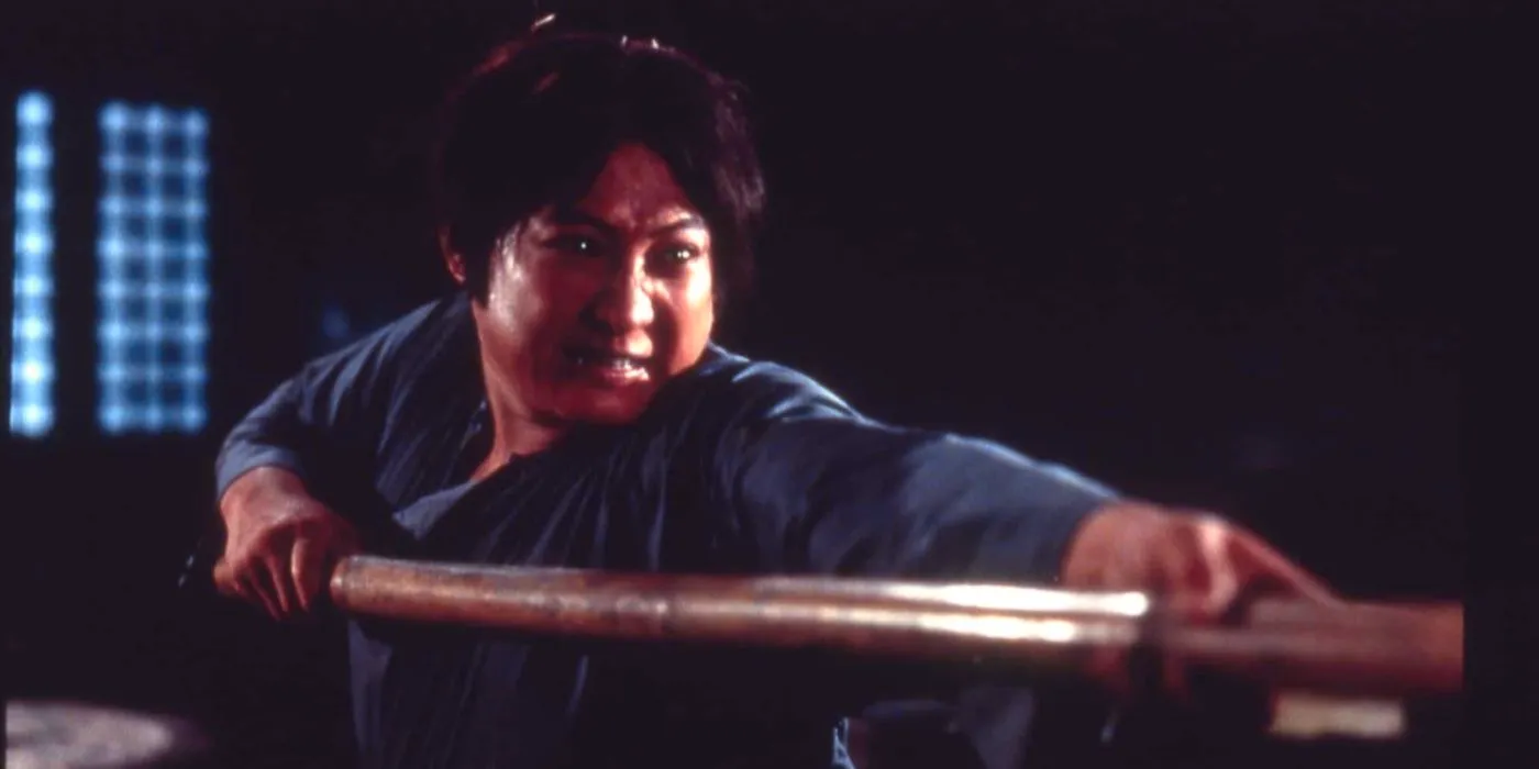 Sammo Hung aims a fighting stick in Encounters of the Spooky Kind 1980 Image