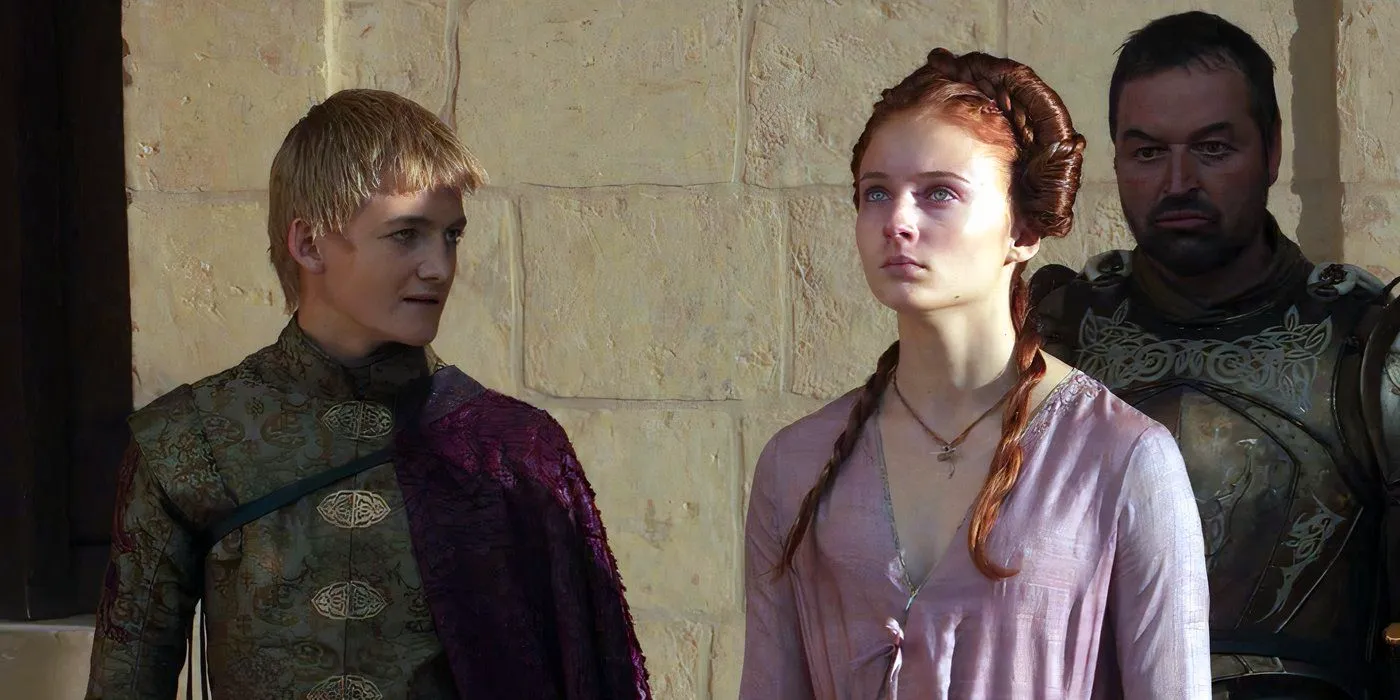 Sansa (Sophie Turner) and Joffrey (Jack Gleeson) looking at Ned's head in Game of Thrones season 1 Image