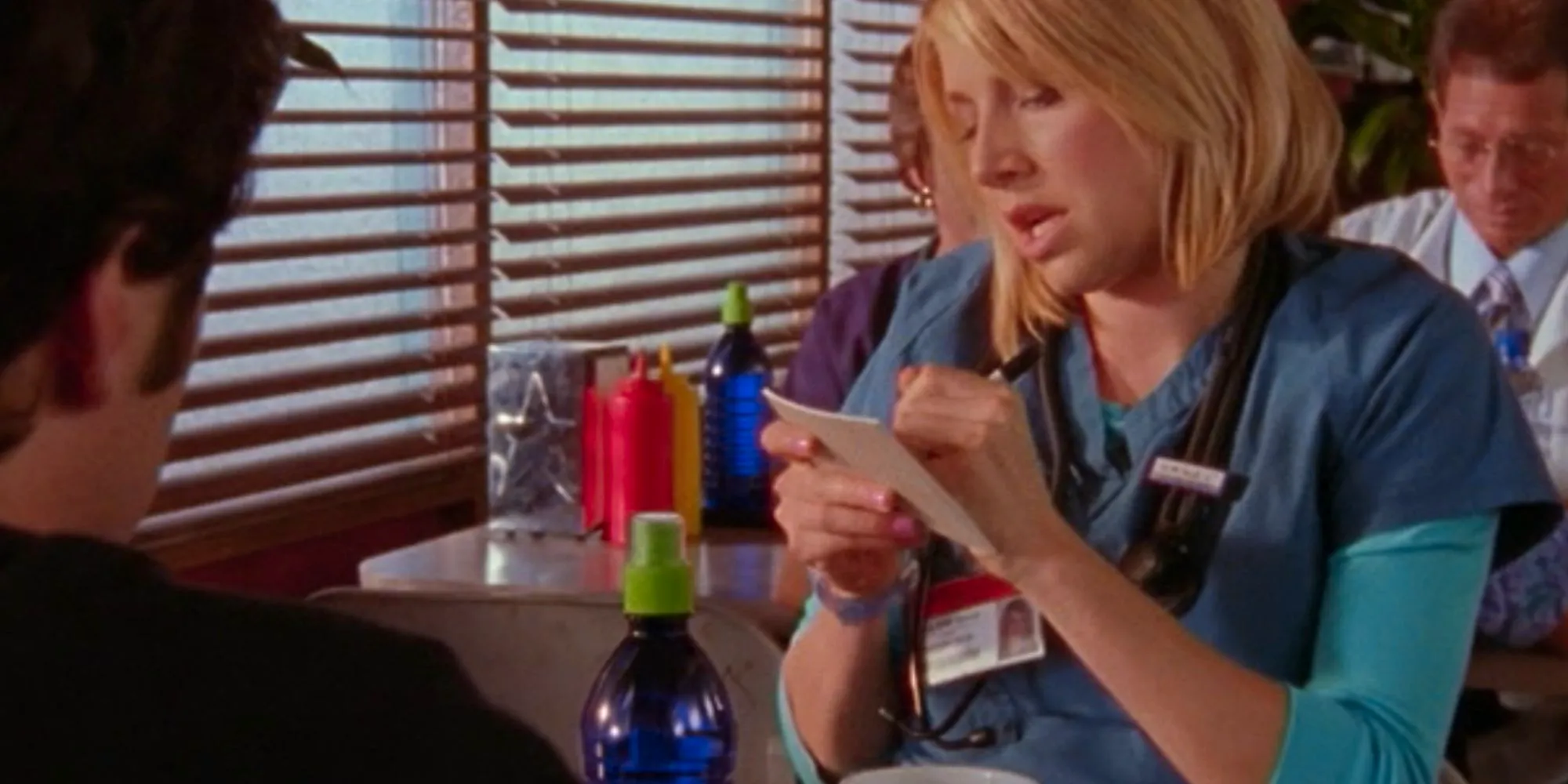 Sarah Chalke as Elliot Reid writing a note for JD in Scrubs Image