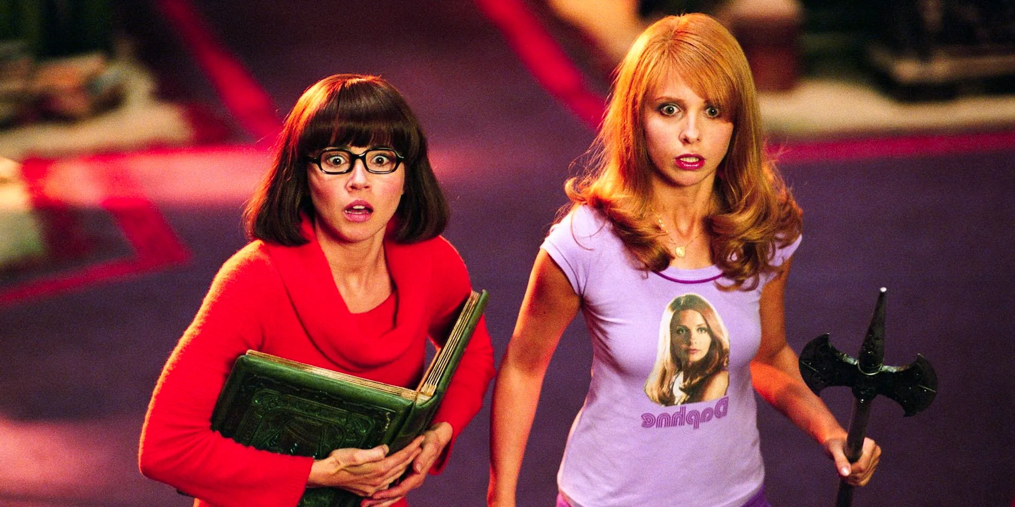 Sarah Michelle Gellar and Linda Cardellini as Daphne and Velma looking shocked in Scooby-Doo Image