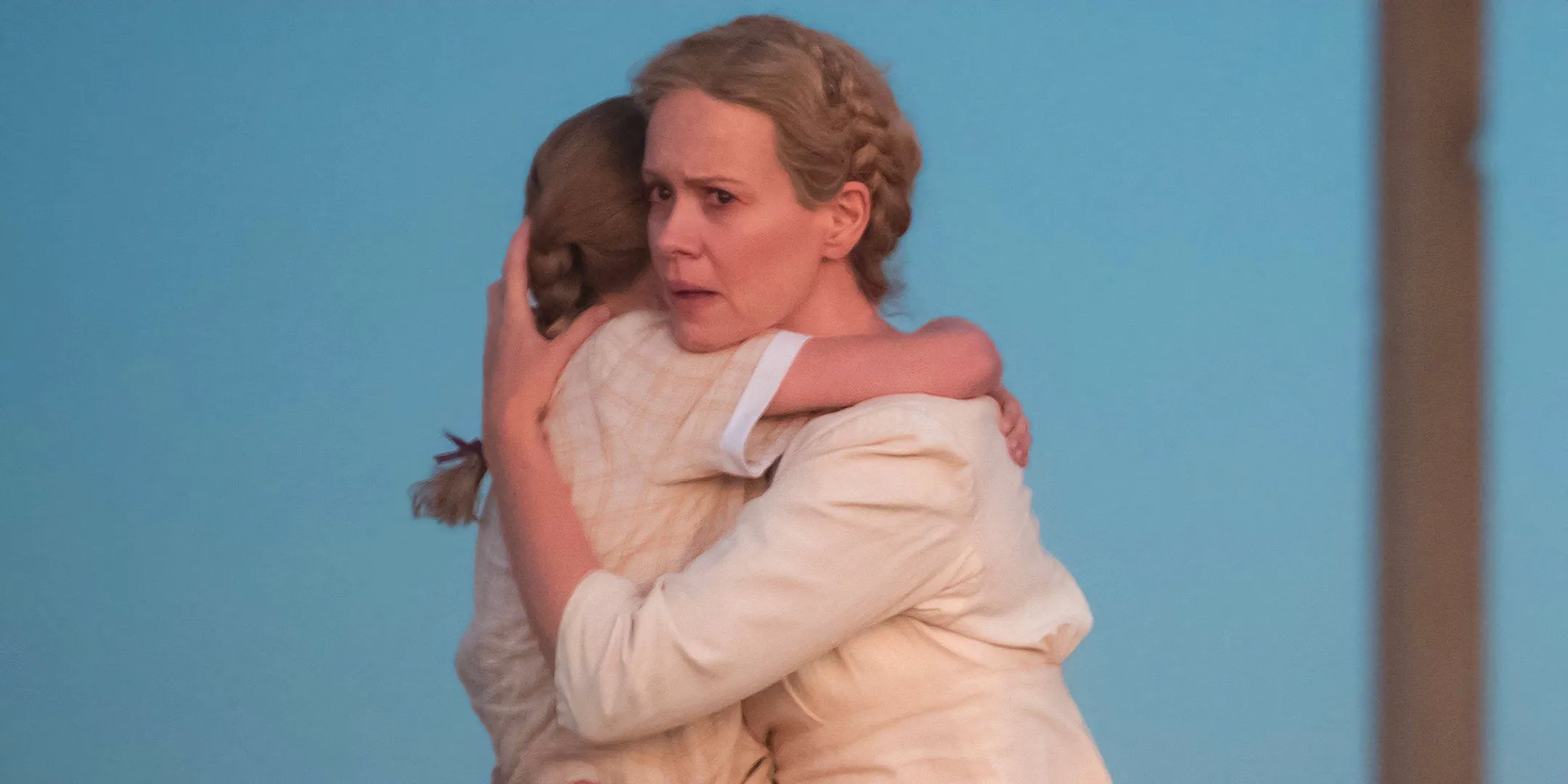 Sarah Paulson as Margaret looking afraid while holding Alona Jane Robbins' Ollie and running in Hold Your Breath Image