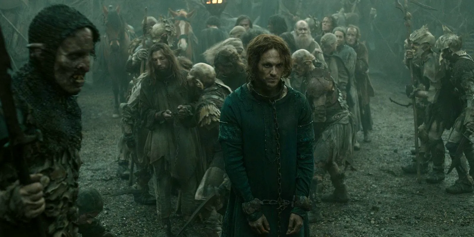 Sauron (Charlie Vickers) is taken prisoner by the orcs and brought before Adar in The Lord of the Rings: The Rings of Power Season 2 Episode 1 Image