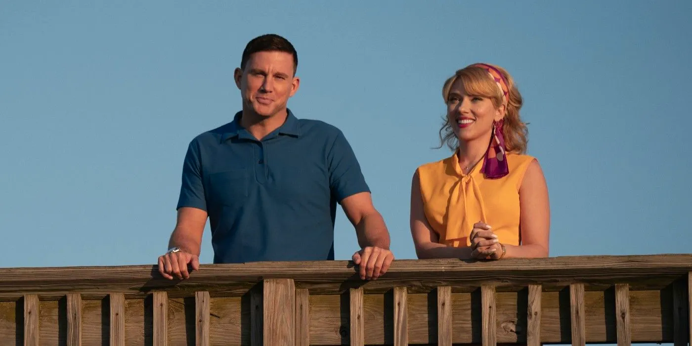 Scarlett Johansson and Channing Tatum standing side by side at the railing of a boardwalk in Fly Me to the Moon Image